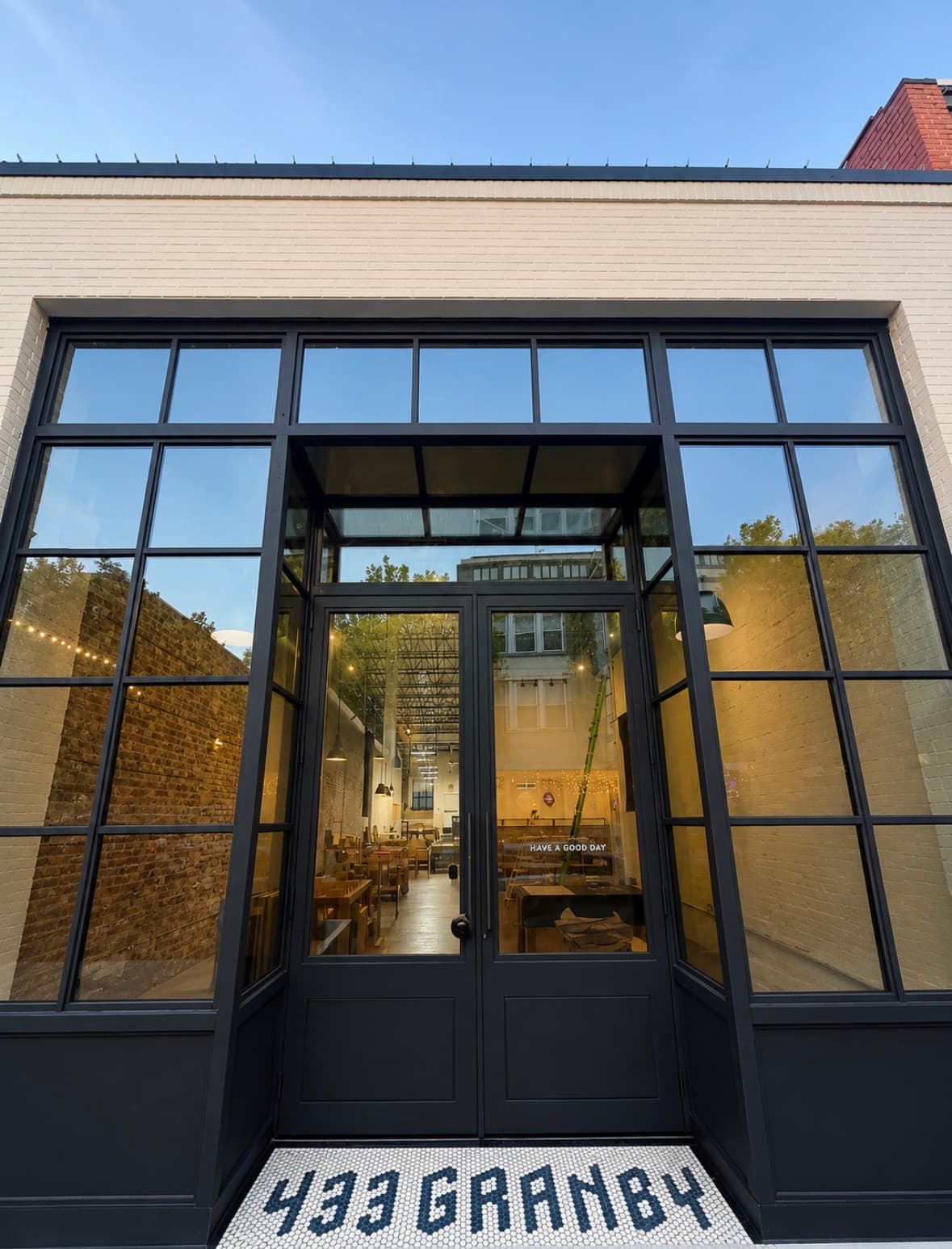 Commercial storefront entrance with large black-framed windows