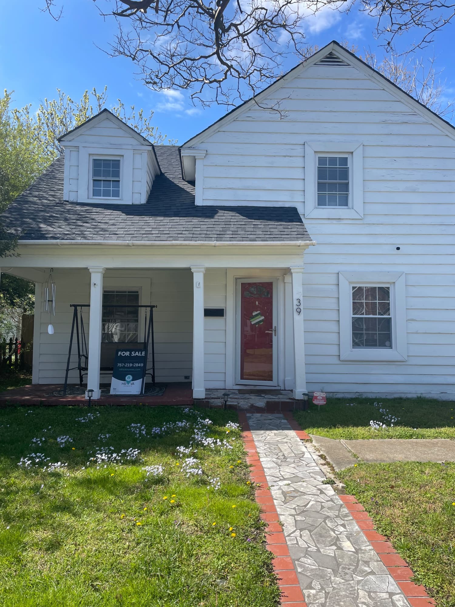White home exterior with a covered porch and front walkway
